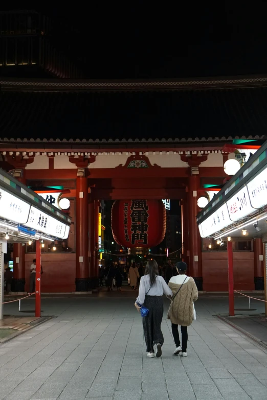 two people walking into a very large building