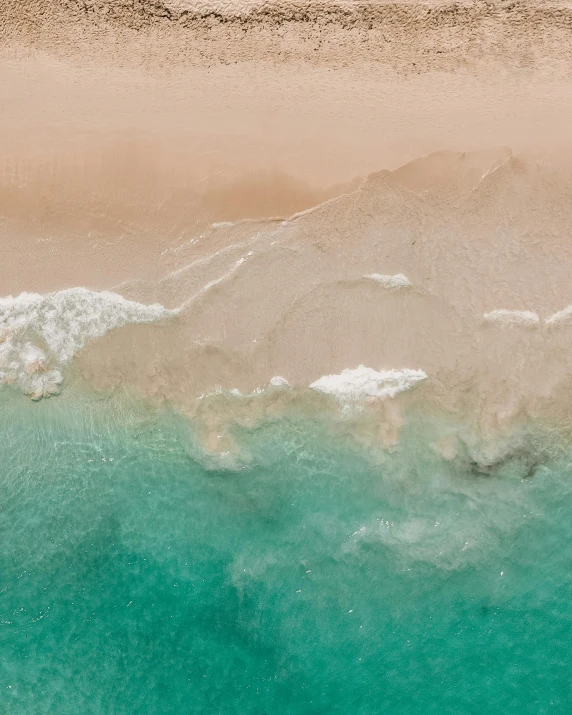 a couple of umbrellas sitting on top of a sandy beach, pexels contest winner, minimalism, cresting waves and seafoam, bird's view, iridescent skin, 1/1000