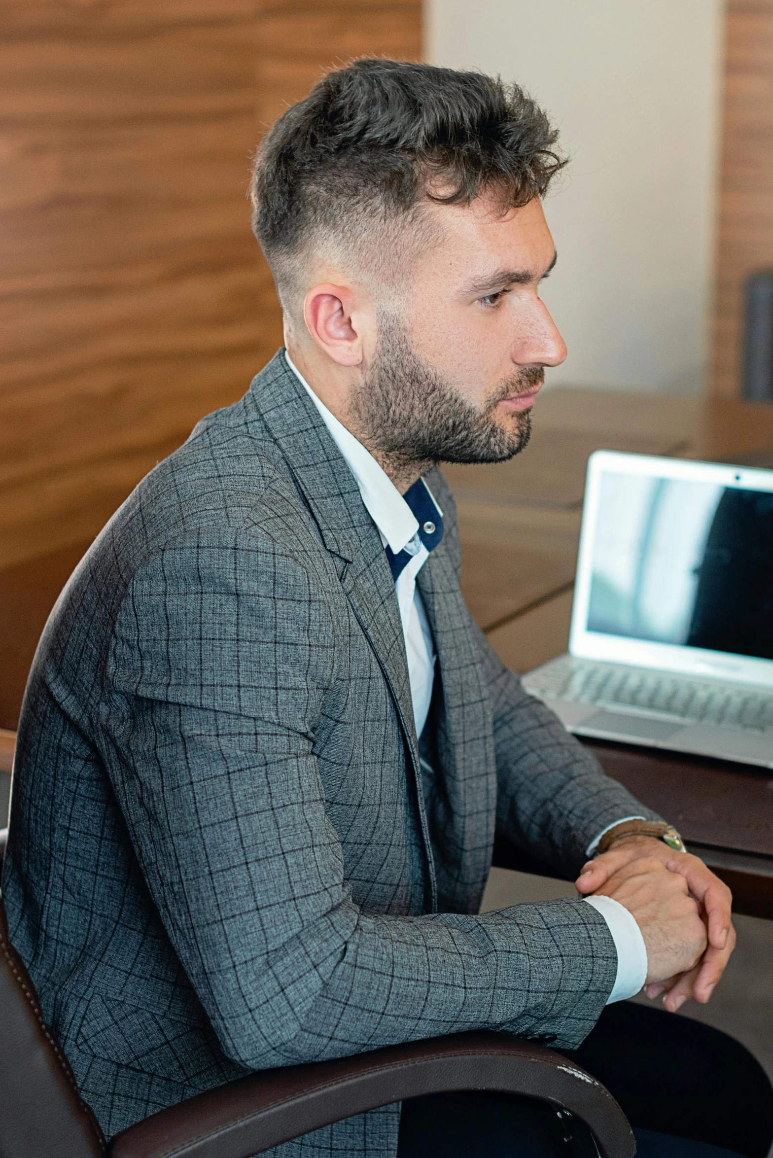 a man sitting in front of a laptop computer