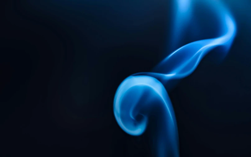 a close up of blue smoke on a black background, a macro photograph, by Adam Marczyński, unsplash, graceful curves, on blue fire, a still of an ethereal, a friendly wisp