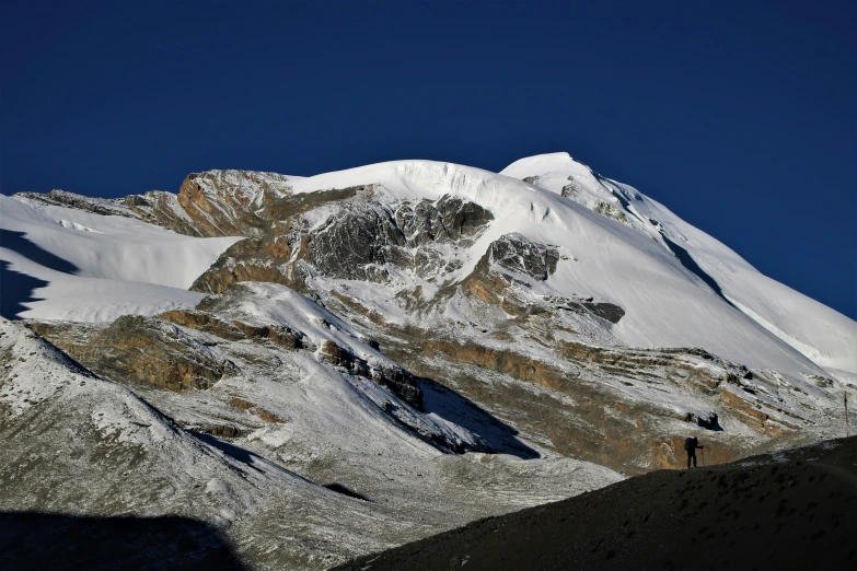 there is a large snow covered mountain in the desert