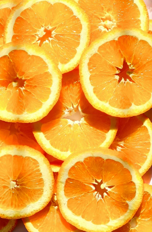 a pile of orange slices sitting on top of a table, zoomed in, uncrop, up-close, yellow aureole