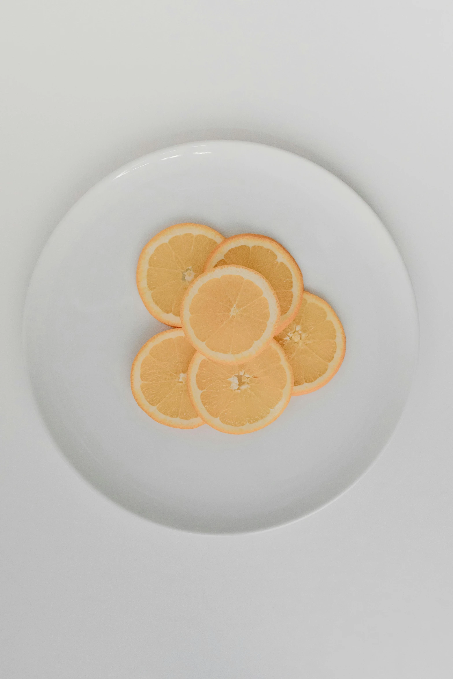 a white plate topped with slices of oranges, 3 mm, 7, - 9, digital image