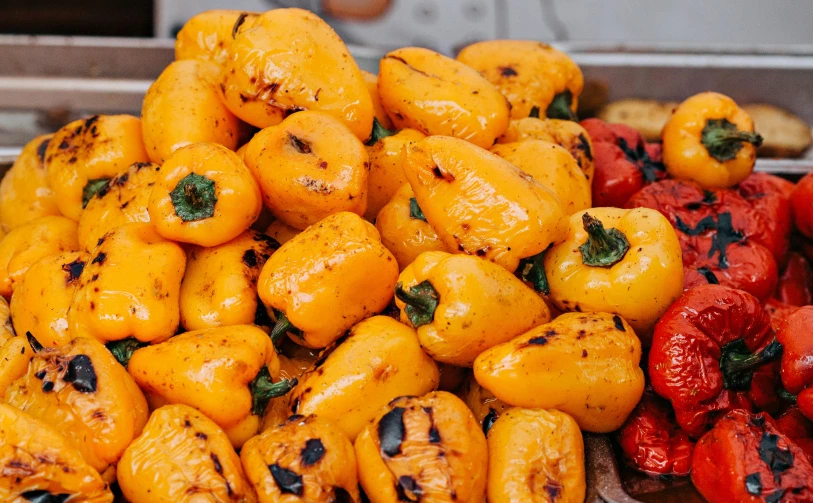 a pile of yellow and red peppers sitting next to each other, a cartoon, unsplash, grilled chicken, middle eastern style vendors, basil gogos, glazed