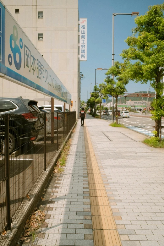 a person is walking down the side of a street