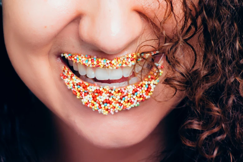 a close up of a person with sprinkles on their teeth, trending on pexels, multi colour, rebecca sugar, made of food, dentist