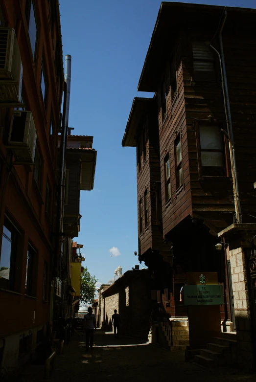 a couple of buildings that are next to each other, a picture, inspired by Nadim Karam, renaissance, shady alleys, wooden buildings, slide show, medium shot angle