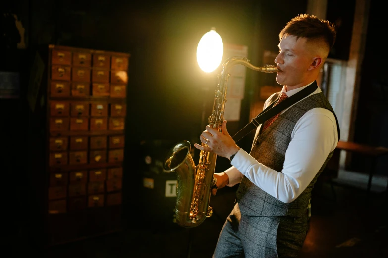 a man plays on the saxophone during the evening