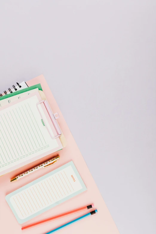 a notepad sitting on top of a pink desk, by Carey Morris, trending on pexels, soft lilac skies, low quality photo, ilustration, stacked image