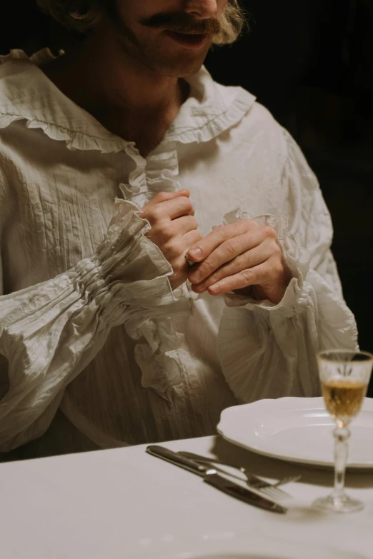 woman holding on to her tie over a glass of wine