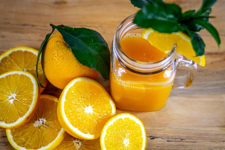 a jar of orange juice next to sliced oranges, a picture, by Jan Tengnagel, pexels, 🦩🪐🐞👩🏻🦳, yellow-orange, moringa juice, thumbnail