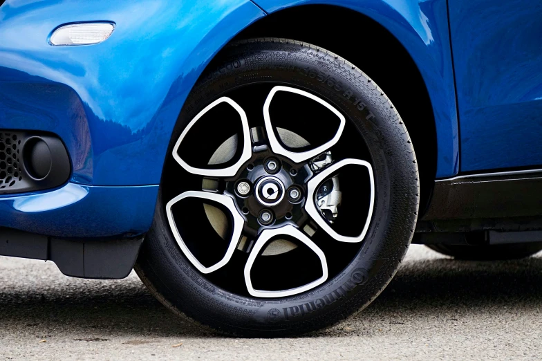 a close up of a tire on a blue car, pixabay, renault ultimo, thumbnail, smart design, hybrid styles