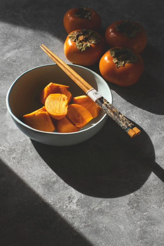 a close up of a bowl of food with chopsticks, a still life, inspired by Inshō Dōmoto, unsplash, hyperrealism, pumpkin, grey orange, background image, made of glazed