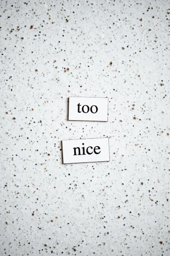 a piece of paper with the words too nice written on it, by Caro Niederer, trending on unsplash, incoherents, made of all white ceramic tiles, taken on iphone 14 pro, minimalist sticker, sarcastic