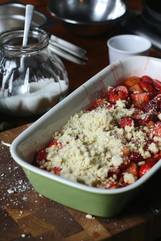 a close up of a pan of food on a table, strawberry, bowl filled with food, bumps, chalk