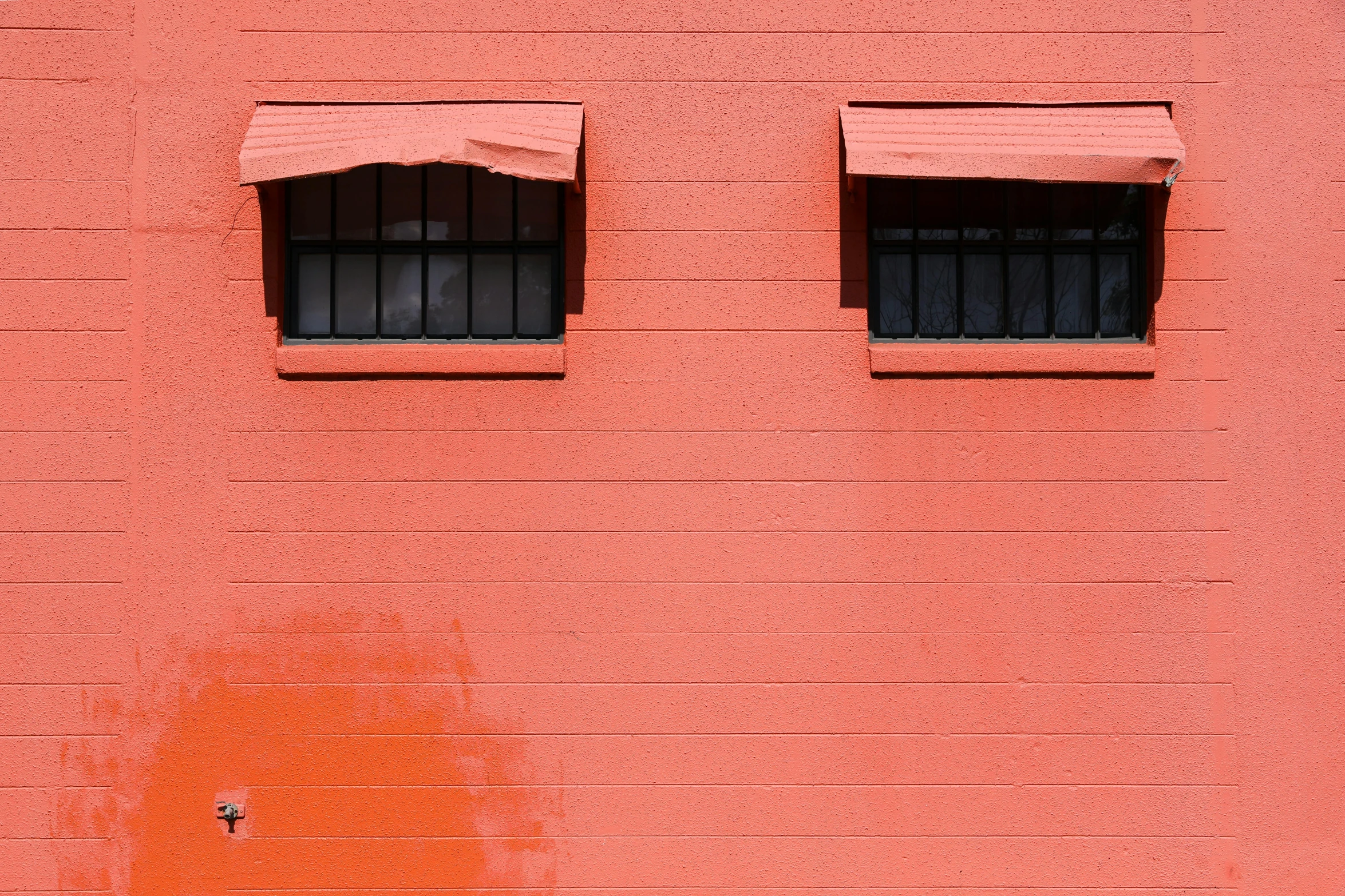 a fire hydrant sitting in front of a red wall, a minimalist painting, inspired by Patrick Caulfield, pexels contest winner, eye ball windows, black and orange, metal shutter, windows and walls :5