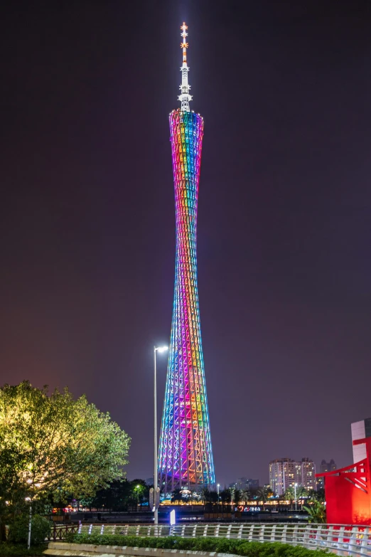 a tall building is brightly lit up in the night