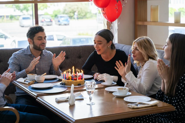 a group of people sitting around a table with a birthday cake, profile image, restaurant, background image, caulfield