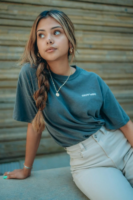 a woman sitting on a ledge with a skateboard, by Robbie Trevino, with ripped crop t - shirt, ((greenish blue tones)), portrait sophie mudd, embroidered shirt