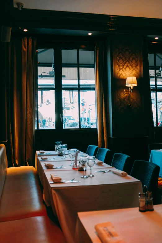 a dining room filled with lots of tables and chairs, unsplash, art nouveau, gourmet michelin restaurant, blue, panorama, grainy