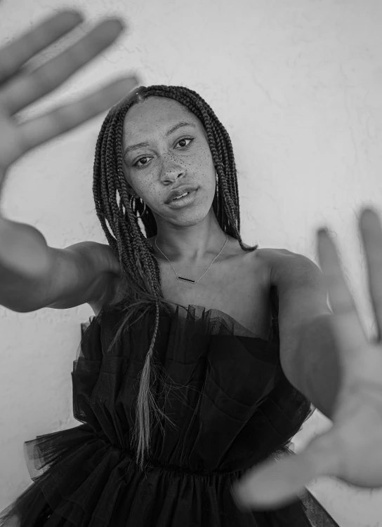 a black and white photo of a woman in a dress, pexels contest winner, box braids, wave a hand at the camera, vanessa morgan, kara walker james jean