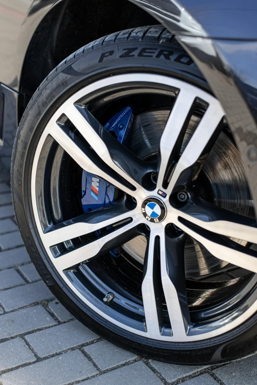 a close up of a car tire on a brick road, bmw i 8, thumbnail, ultradetail, 84mm)