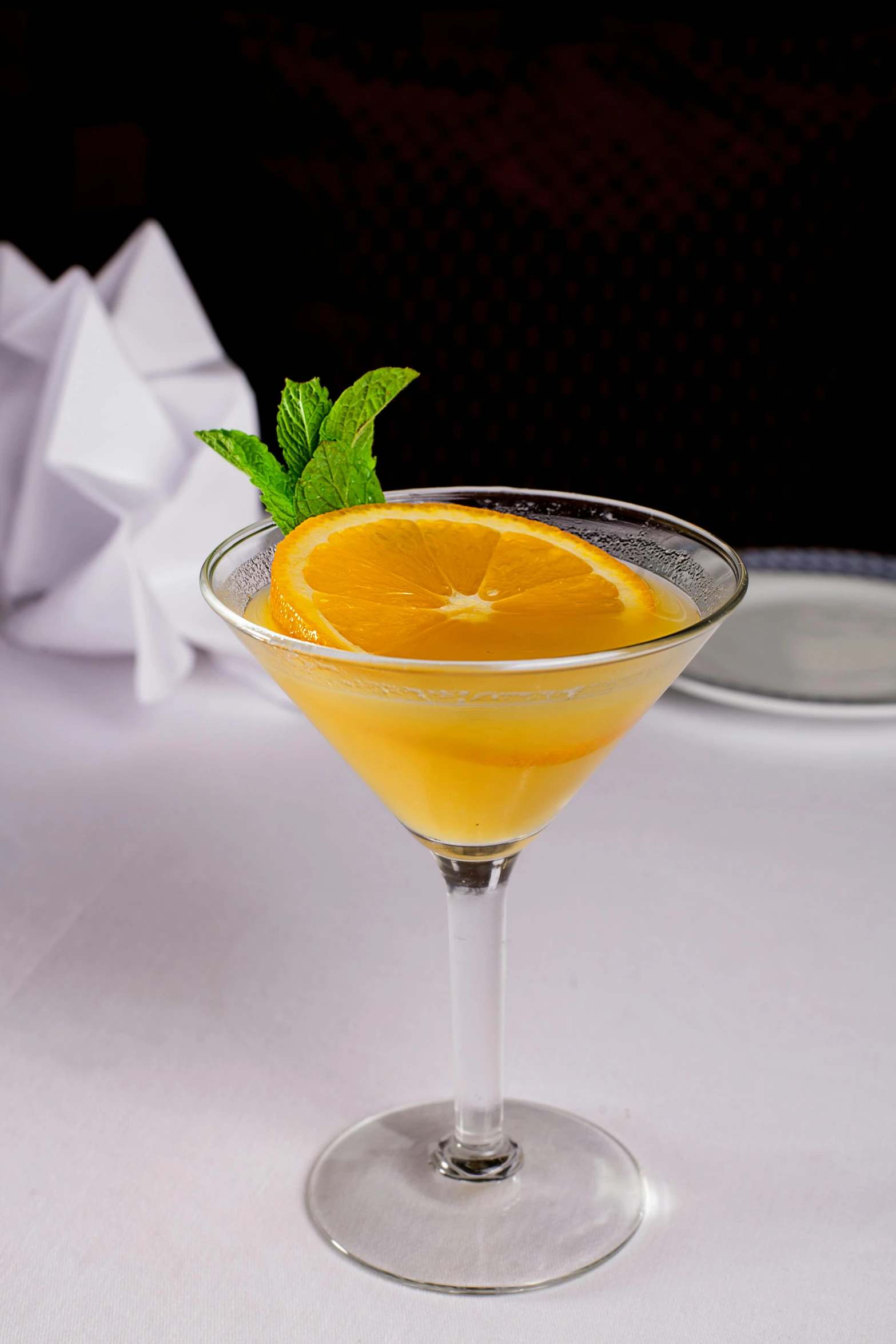 a cocktail sitting on top of a white table, yellow-orange, !!award-winning!!, daily specials, serving suggestion