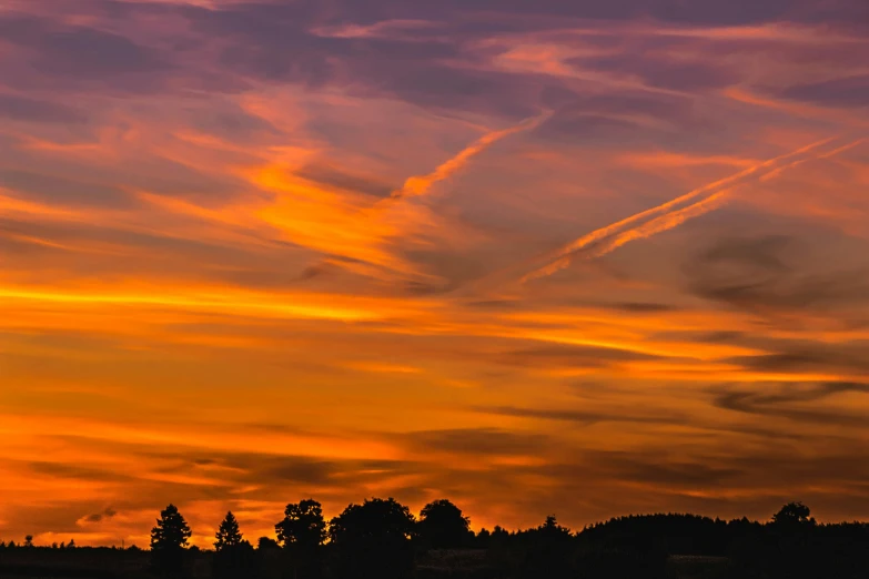 there is a plane that is flying in the sky, by Peter Churcher, pexels contest winner, romanticism, sunset panorama, vibrant orange, mixed art, landscape photograph