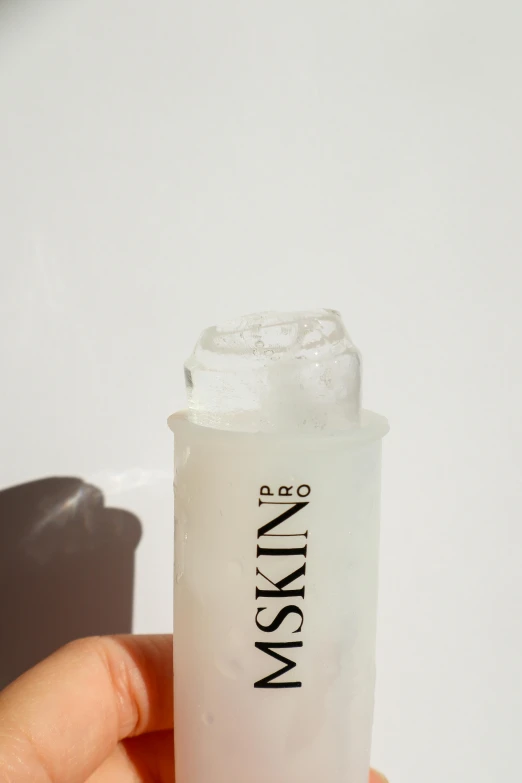 a close up of a person holding a bottle of liquid, by Kristin Nelson, purism, silicone skin, miko, on clear background, freezing