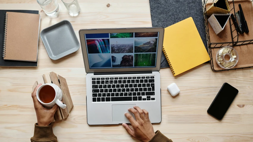 a laptop computer sitting on top of a wooden table, trending on pexels, flatlay, national geographics, a photo of a man, opening shot