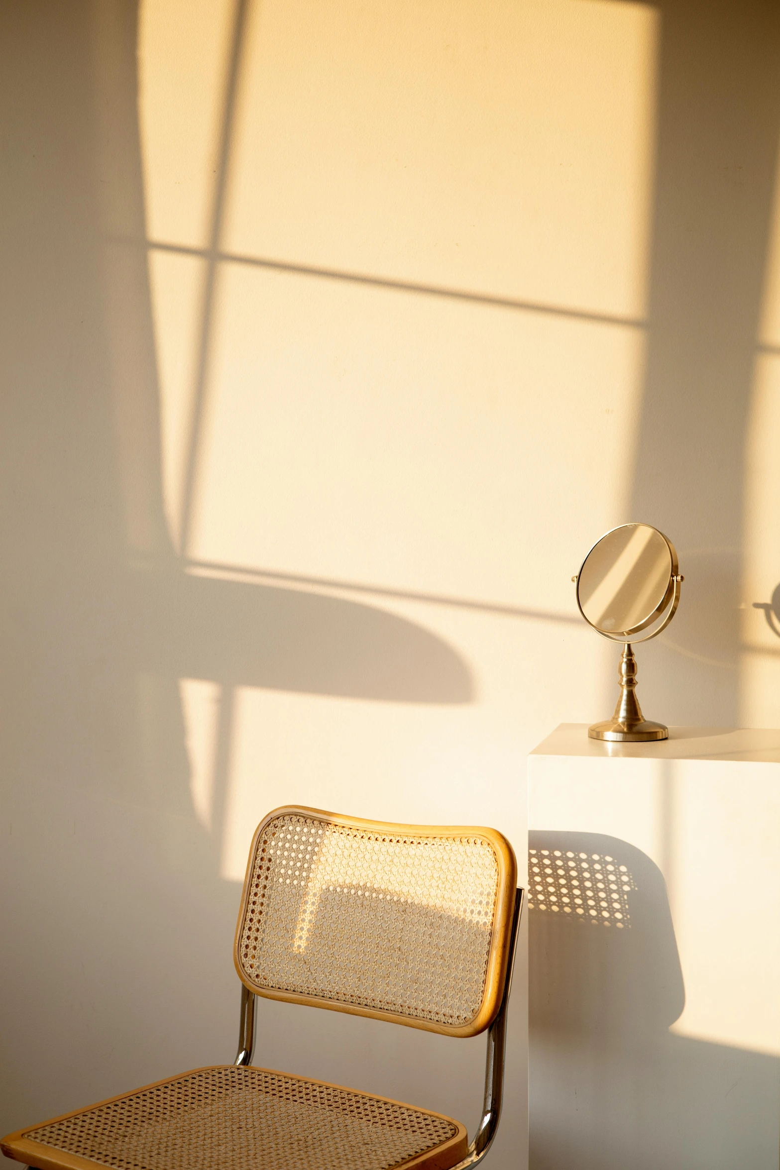 a chair sitting in front of a mirror in a room, by Gavin Hamilton, trending on unsplash, light and space, soft golden hour lighting, cast shadows, background image, a sunny bedroom