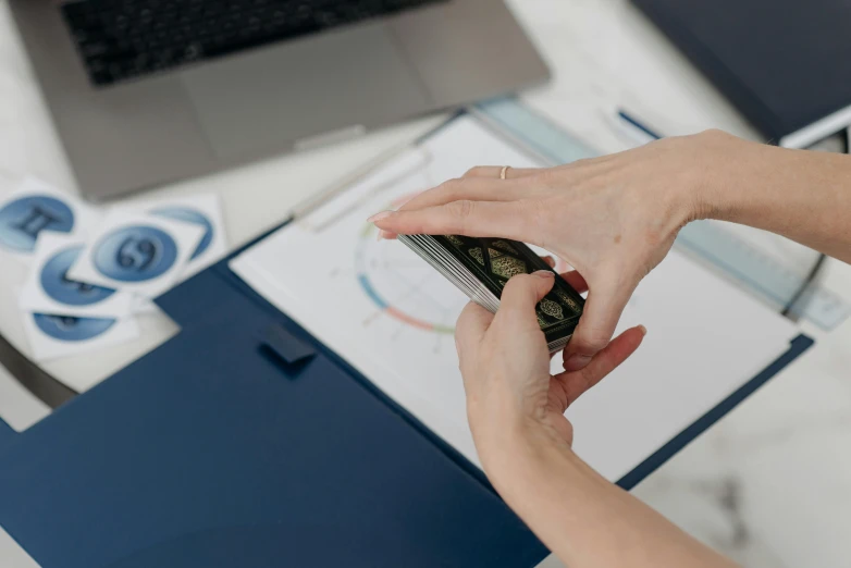 a close up of a person holding a cell phone, on a desk, avatar image, maths, wētā fx