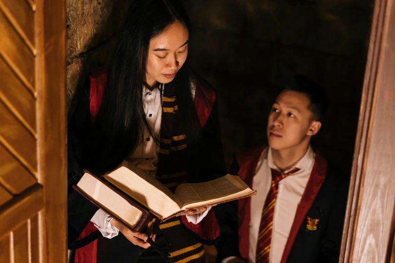 a woman standing next to a boy holding a book, pexels contest winner, hogwarts stairwell, ross tran and bayard wu, [ theatrical ], casting a root spell