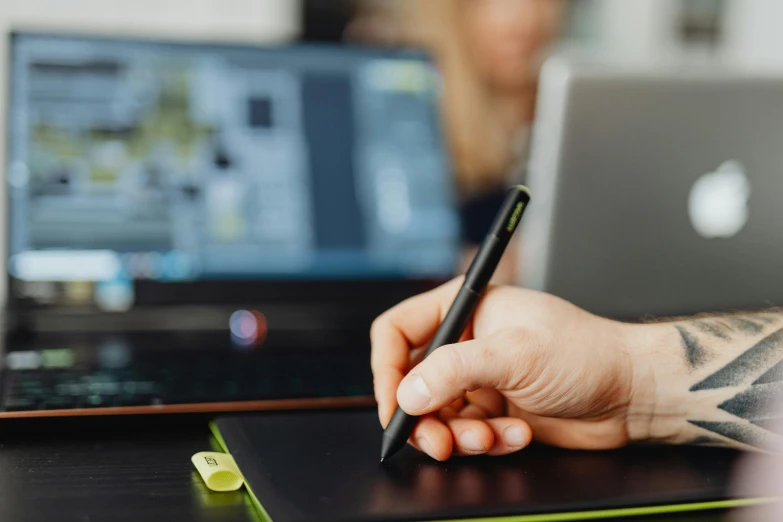 a person sitting at a desk with a laptop and a pen, a digital rendering, by Carey Morris, trending on pexels, draw with wacom tablet, close up to the screen, nvidia and behance, teaching