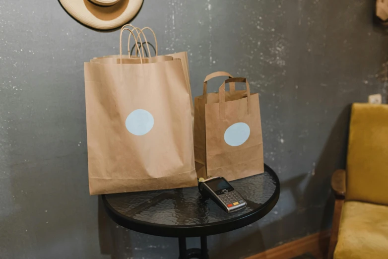 two paper bags are sitting on a table