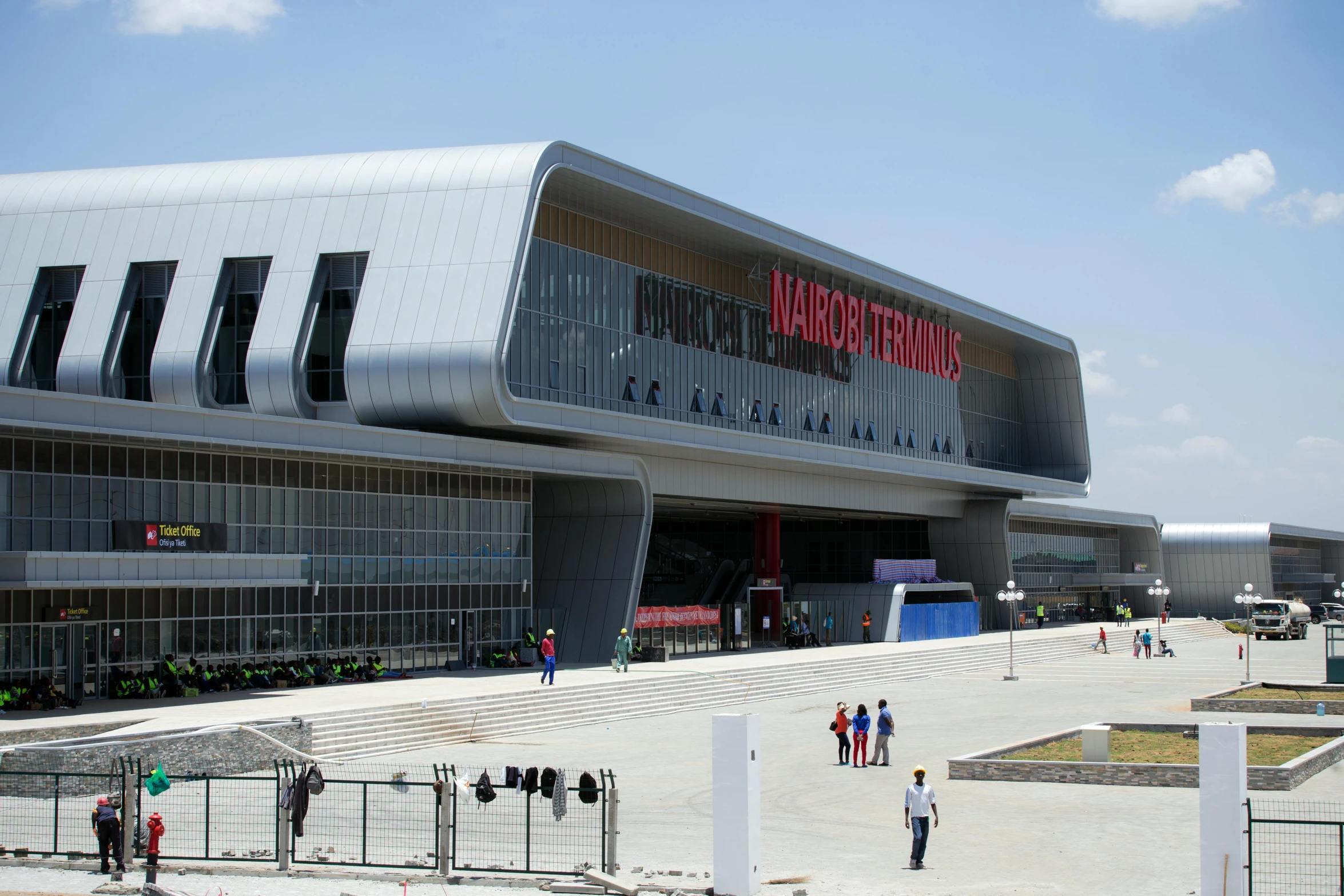 a group of people standing in front of a building, terminal, am a naranbaatar ganbold, massive architecture, trending arstationhq