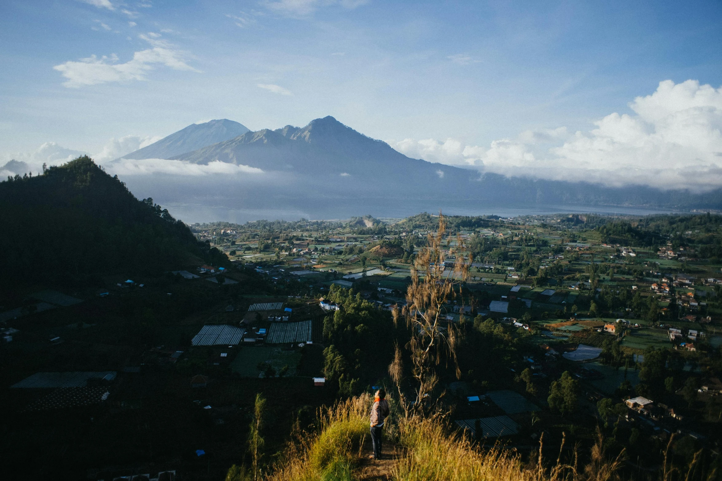 a man standing on a mountain looking at the sky