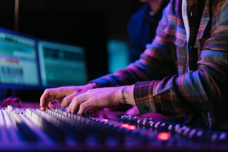 a close up of a person typing on a keyboard, an album cover, pexels, purple scene lighting, graded with davinci resolve, musicians playing instruments, worship