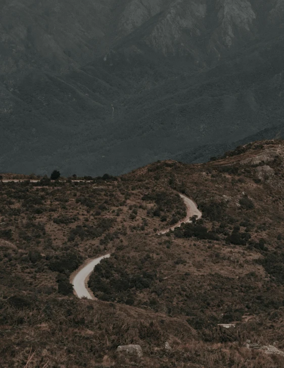 a very winding road going up a mountain side