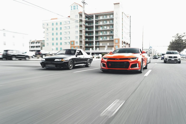 two vehicles going down the road with other cars