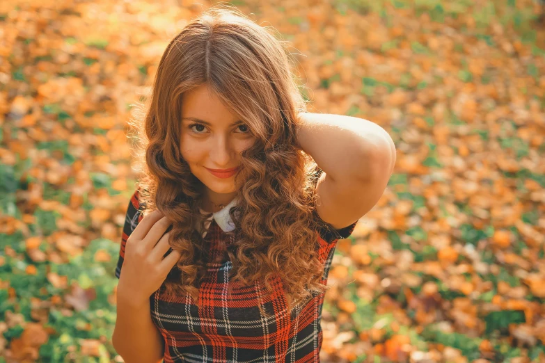 a beautiful young woman standing in a field of leaves, pexels contest winner, brown fluffy hair, 15081959 21121991 01012000 4k, russian girlfriend, wavy hairstyle