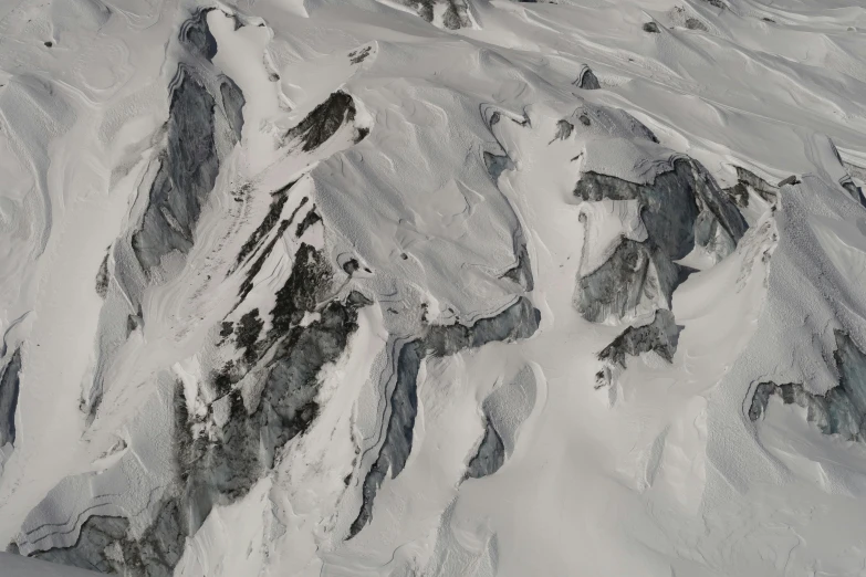 an aerial view of a mountain covered in snow