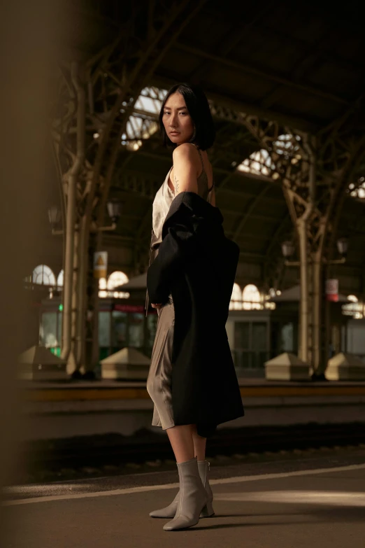 a woman that is standing in a train station