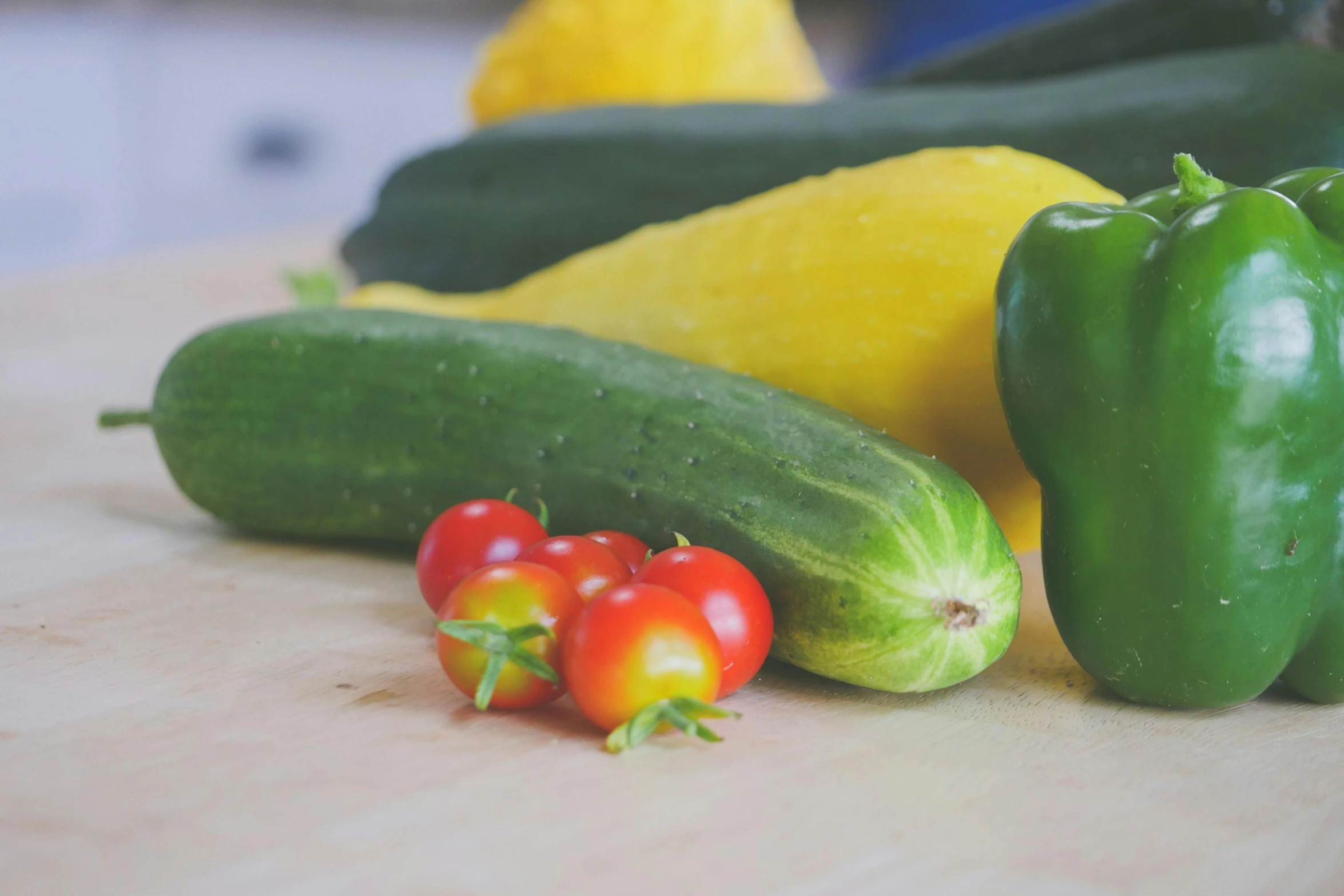 a wooden cutting board topped with cucumbers and tomatoes, by Carey Morris, unsplash, green and yellow, avatar image, leaked image, background image