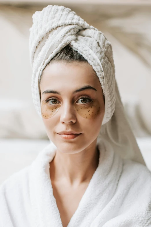 a woman with a towel wrapped around her head, a portrait, trending on pexels, renaissance, black spot over left eye, brunette, bags under eyes, wearing robe