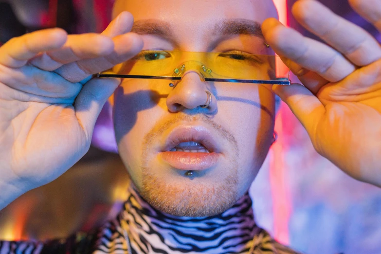 a close up of a person holding a pair of scissors, inspired by David LaChapelle, maximalism, amber glasses, shaved face, mac miller, looking up at camera