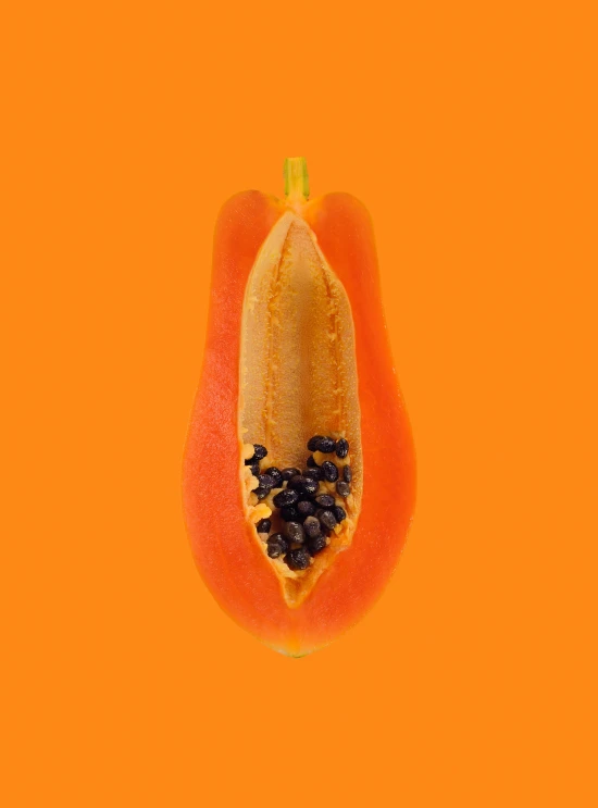 a papana cut in half on an orange background, abundant fruition seeds, highly upvoted, on clear background, pod