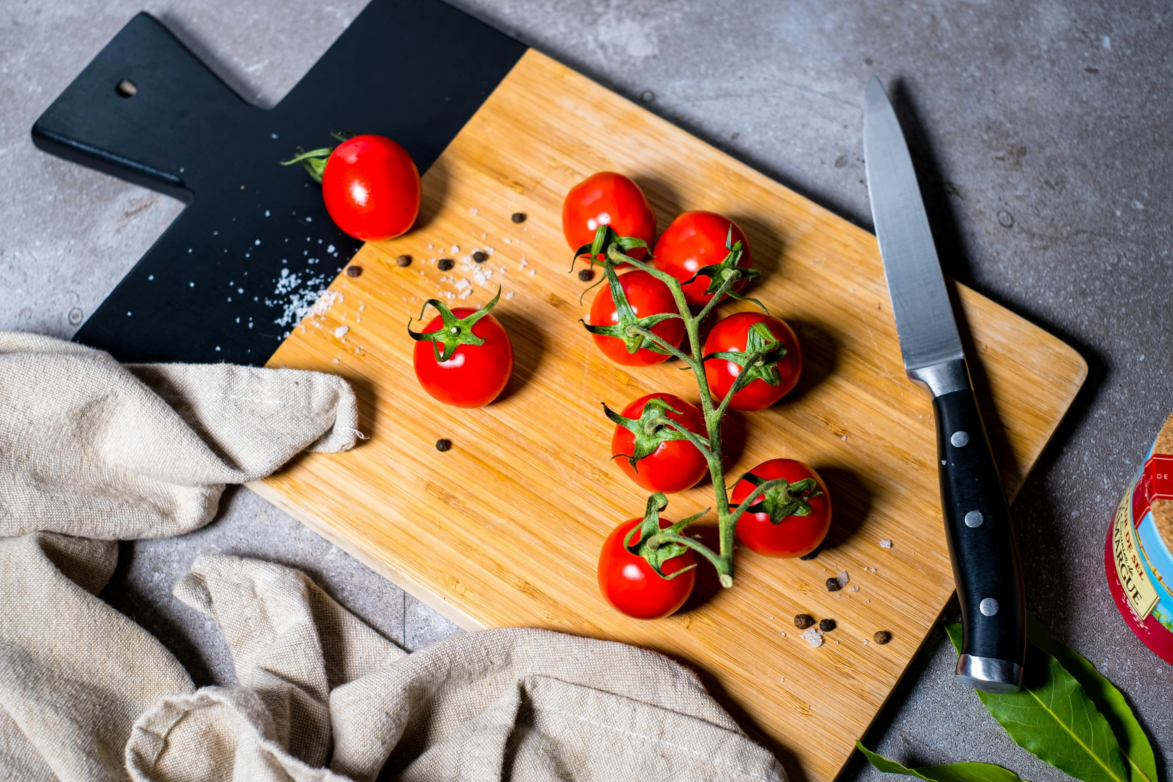 a cutting board topped with tomatoes next to a knife, by Julia Pishtar, decoration, thumbnail, stems, easy to use