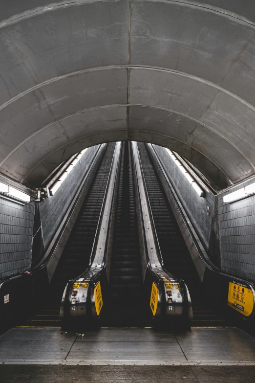 two escalators next to each other on a concrete surface