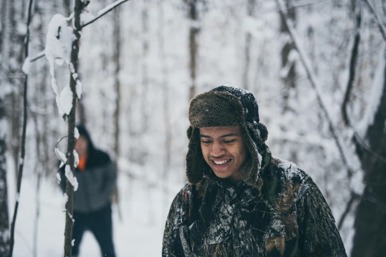 a man that is standing in the snow, forest picnic, smiling spartan, lee madgwick & liam wong, candid